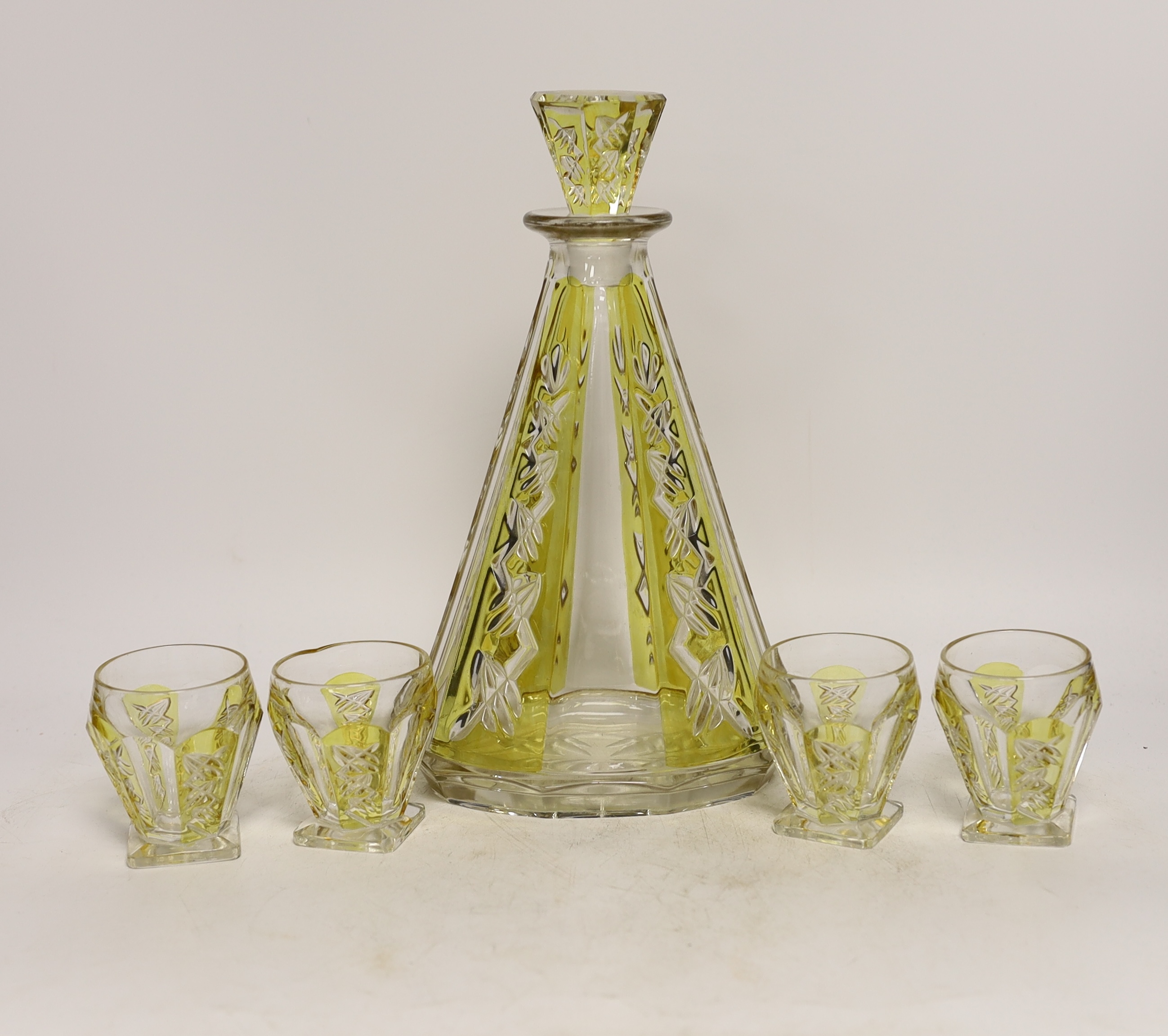 An Art Deco cut glass decanter with four glasses, decanter 29cm high